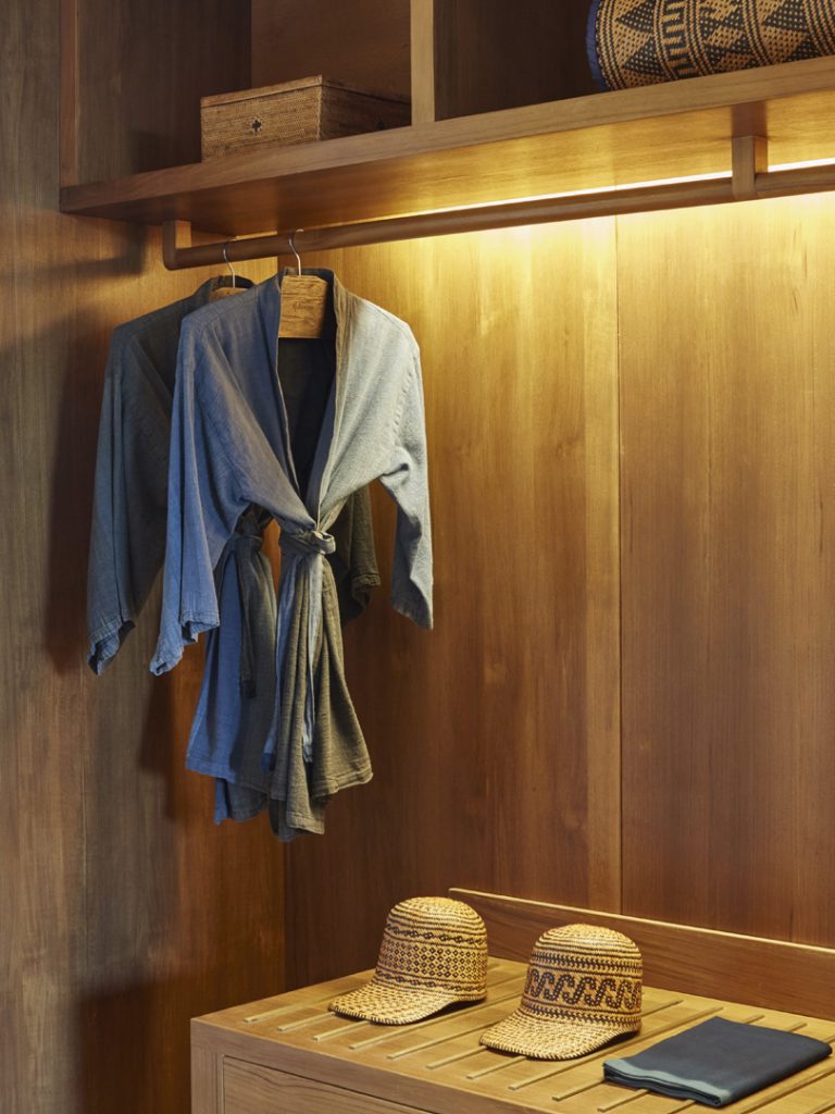 Bath robes hung on an open concept wardrobe in the suites at Potato Head Suites located at Desa Potato Head in Seminyak, Bali.
