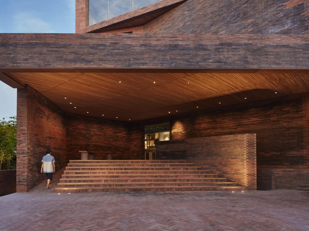 The wooden and brick exterior of the luxurious Potato Head Suites located at Desa Potato Head in Seminyak, Bali.