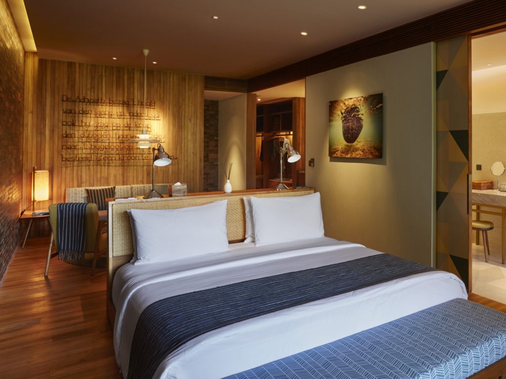 The sleeping and living area of the Island Suite at Potato Head Suites, located at Desa Potato Head in Seminyak, Bali.