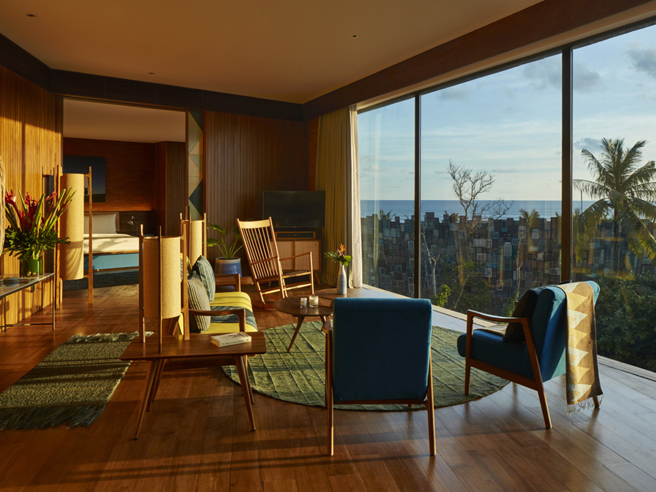 The living area in one of the luxury suites at Katamama Hotel in Seminyak, with full-length windows overlooking the Desa.