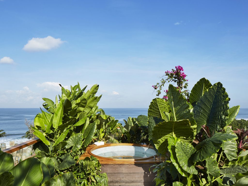 Private jacuzzi area surrounded by lush greenery at the Potato Head Suites, located at Desa Potato Head in Seminyak, Bali.