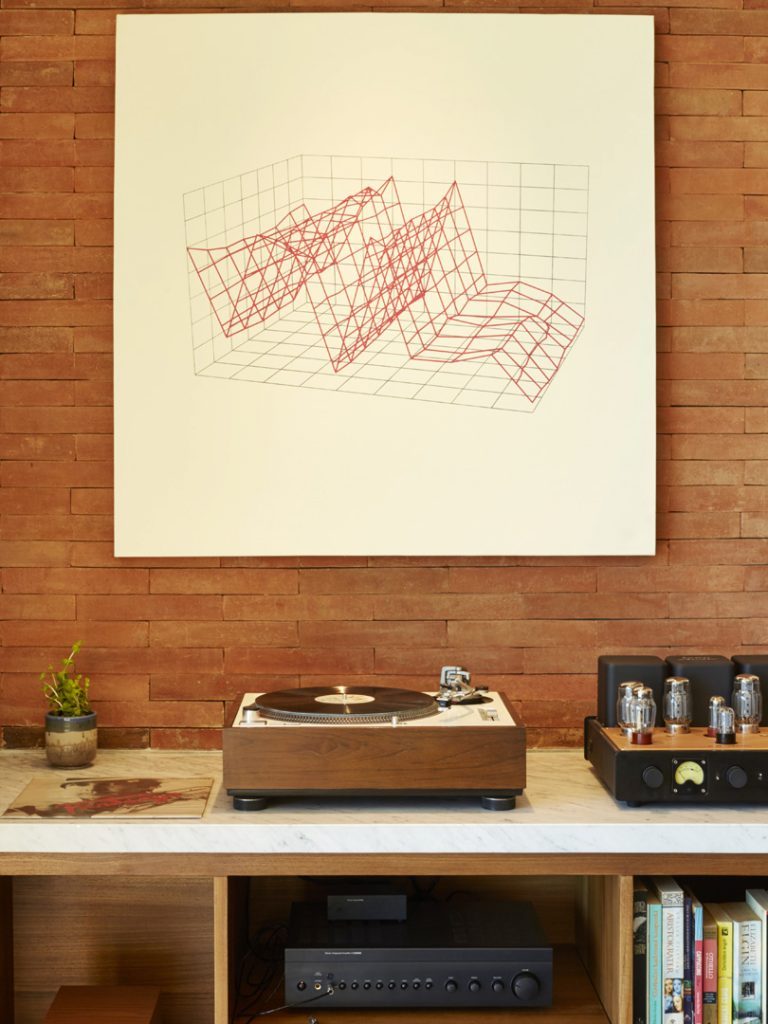 A vinyl player and minimalist wall art in one of the luxury suites at Potato Head Suites in Seminyak, Bali