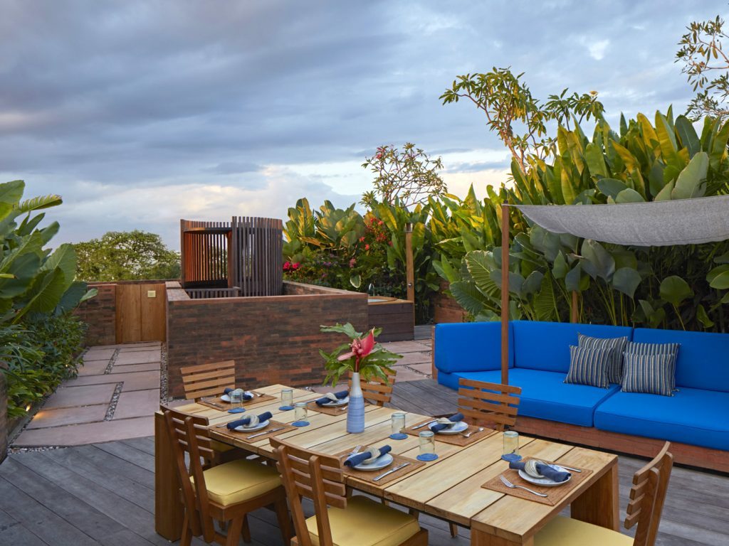 The Rooftop Suite at Potato Head Suites features a private terrace with comfortable seating areas as well as a dining area.