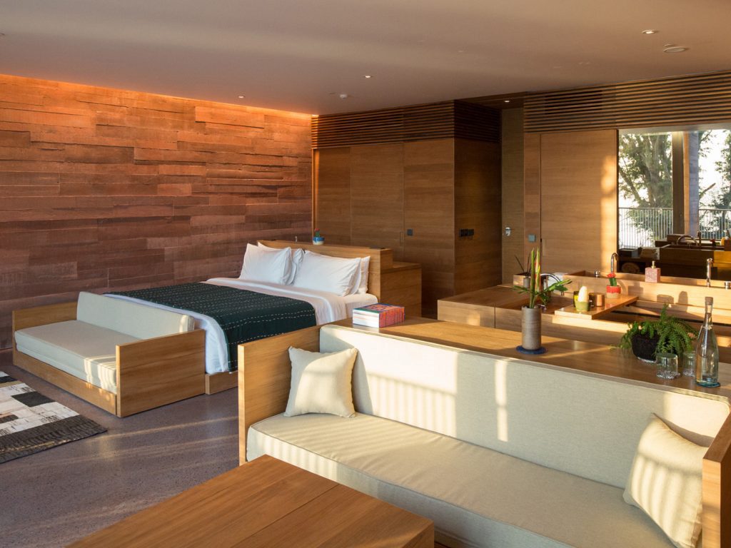 The interior of the Oceanfront Studio at the Potato Head Studios in Seminyak, featuring the sleeping, bath and living areas.