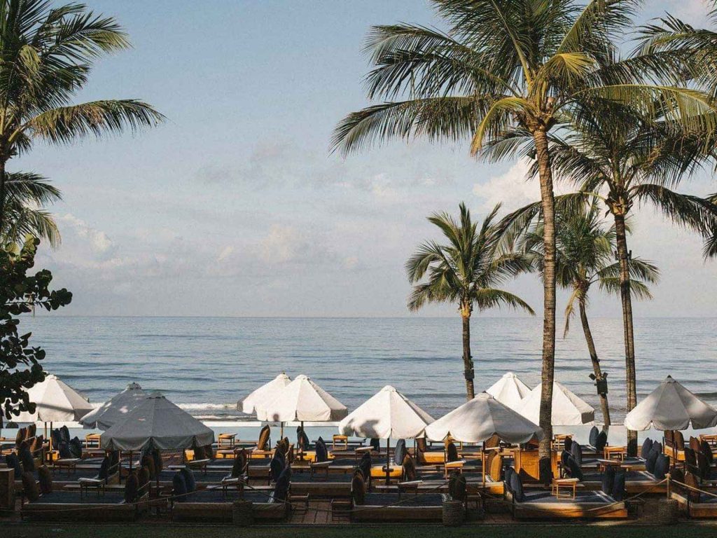 View of coconut trees and the ocean from Potato Head Suites located at Desa Potato Head in Seminyak, Bali.