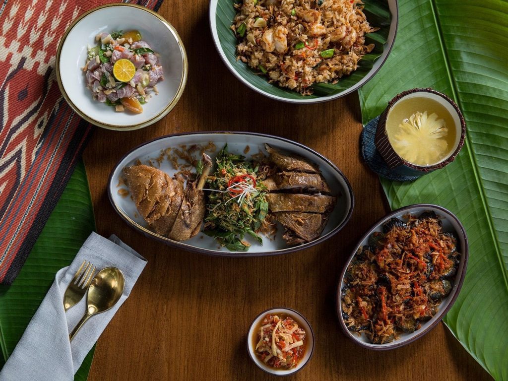 An assortment of dishes served at Kaum restaurant in Seminyak, including Nasi Goreng Udang, Gohu Ikan Tuna and Bebek Goreng.