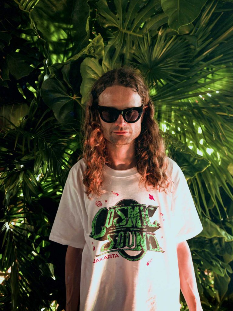 Nils Schéle from Junior Executive is wearing Cosmic Sound white t-shirt at Desa Potato Head Seminyak, Bali