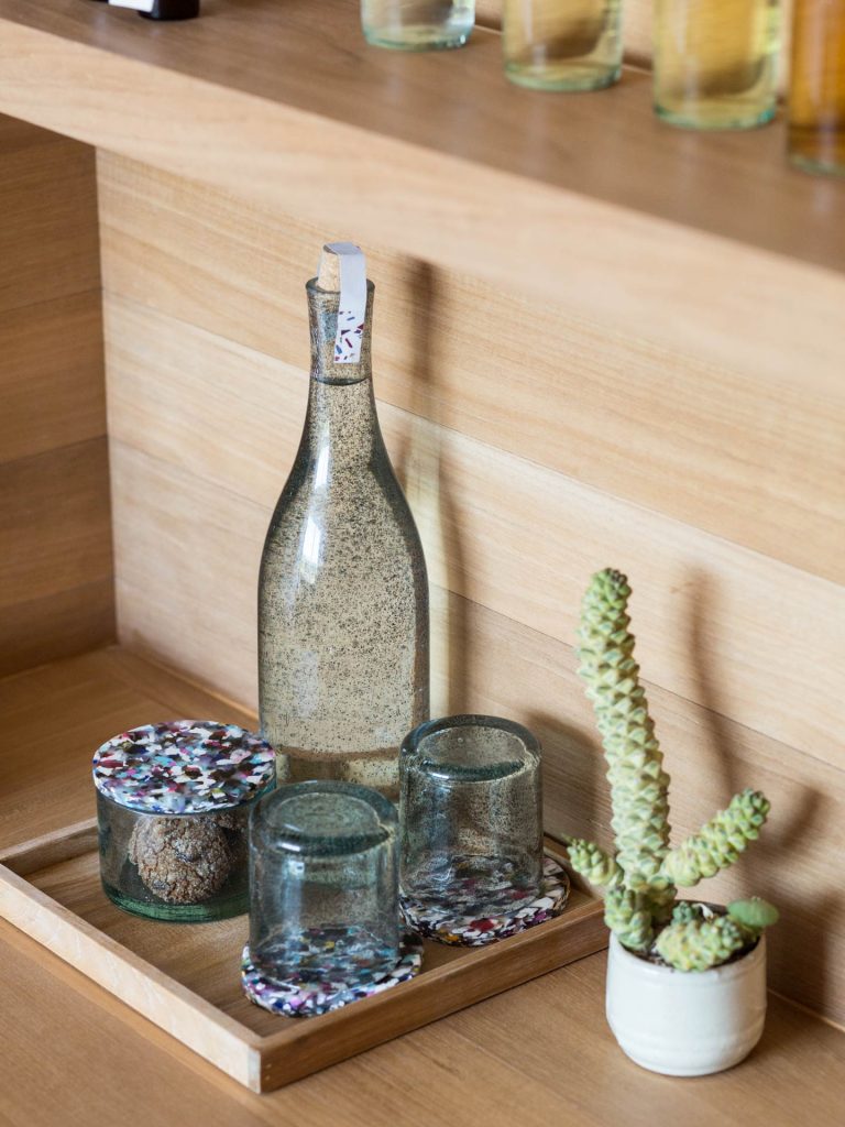 Bottled water with a small jar of cookies are part of the amenities provided at Potato Head Studios in Seminyak, Bali.
