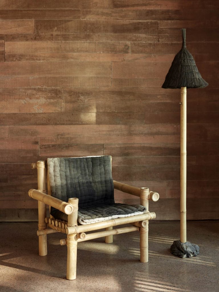 A bamboo arm chair with a matching standing lamp in one of the studios at the Potato Head Studios in Seminyak, Bali.